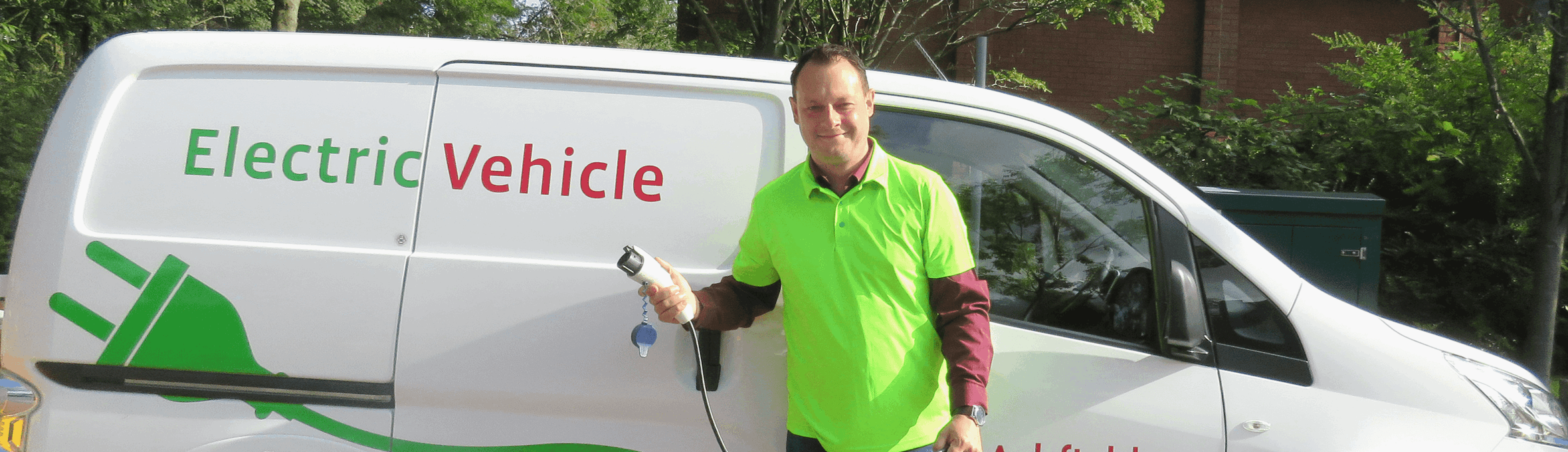Cllr Jason Zadrozny sttod in front of electrically charged white van 