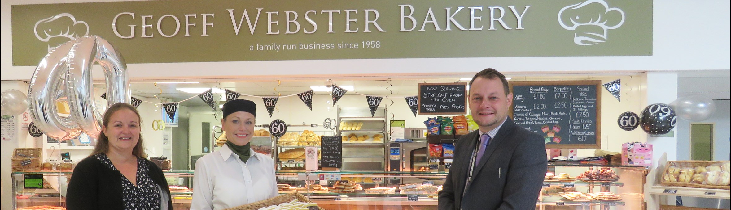 cllrs stand outside Geoff Webster Bakery in Idlewells Indoor Market 