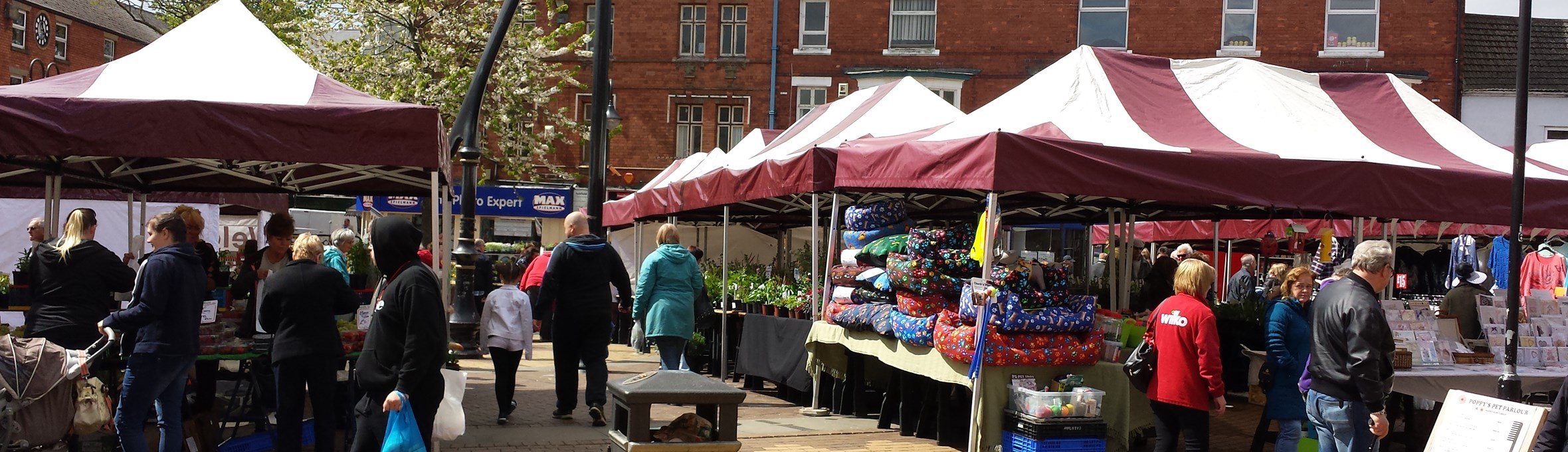 Sutton Market place with stalls set out and people shopping