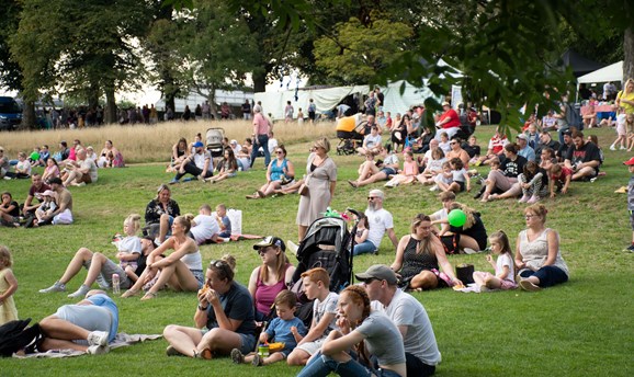 crowds of people sat on the hill on Sutton Lawn watching the cinema screen