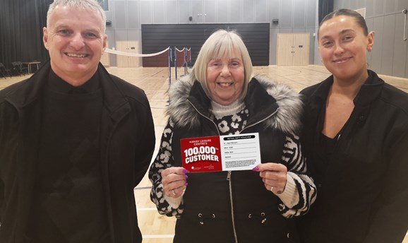 Jean Patterson, the 100,000th visitor at Kirkby Leisure Centre, receiving her £100 voucher.