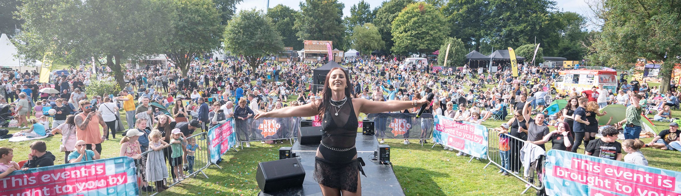 A performer on the stage surrounded by the crowds at a previous Ashfield Show