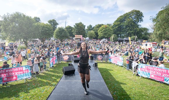 A performer on the stage surrounded by the crowds at a previous Ashfield Show