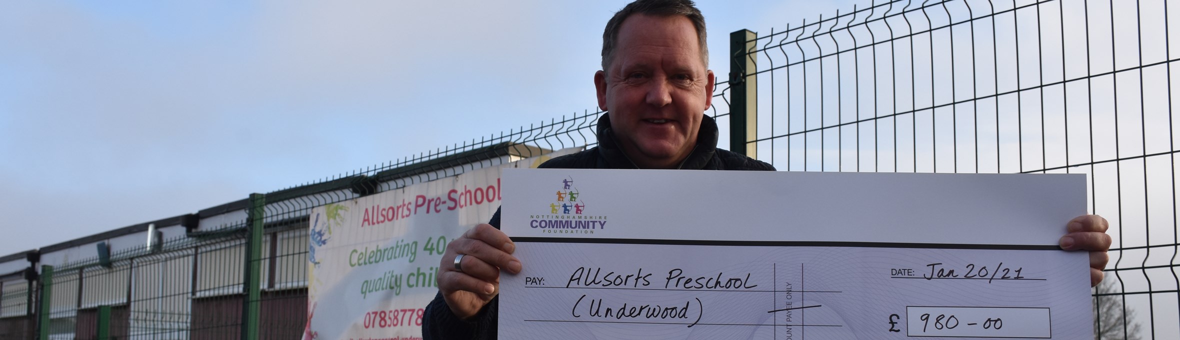 Councillor David Martin at Allsorts Preschool in Underwood with their grant cheque in 2020