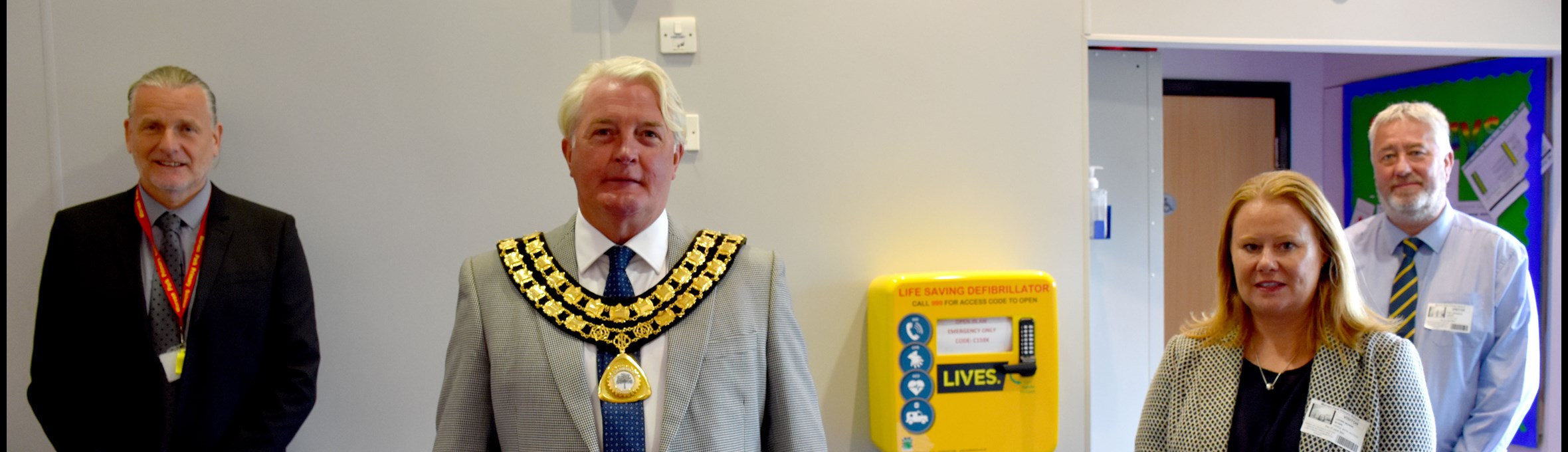 Council Chairman Arnie Hankin with a defibrillator 