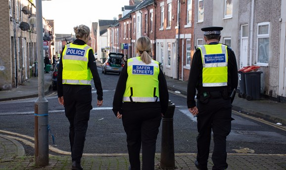 Police and community protection officers on patrol in high vis vests