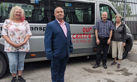 Cllr Kier Barsby with Our Centre staff stood in front of their mini bus