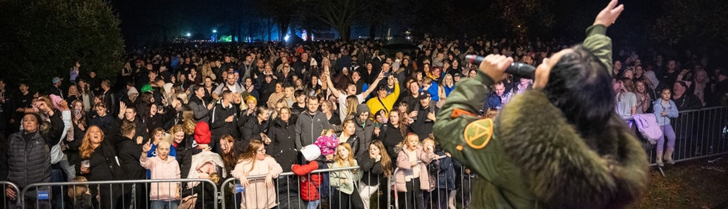 Crowds watch the entertainment on stage at Sparks in the Park 2024