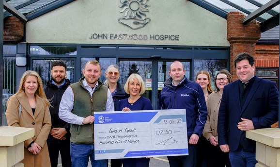 Councillors, Lindum representatives and Hospice staff stood outside the hospice with a large cheque.