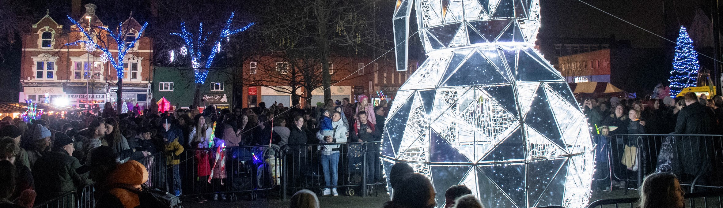 Crowds stand around a giant LED snowman in Hucknall 