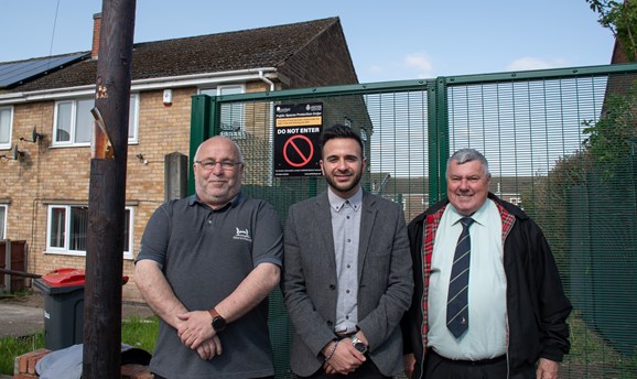 Cllr Andy Meakin, Antonio Taylor, and Cllr Warren Nuttall outside the gate on Beacon Drive 