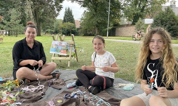 A woman and two girls craft making at Mill Waters