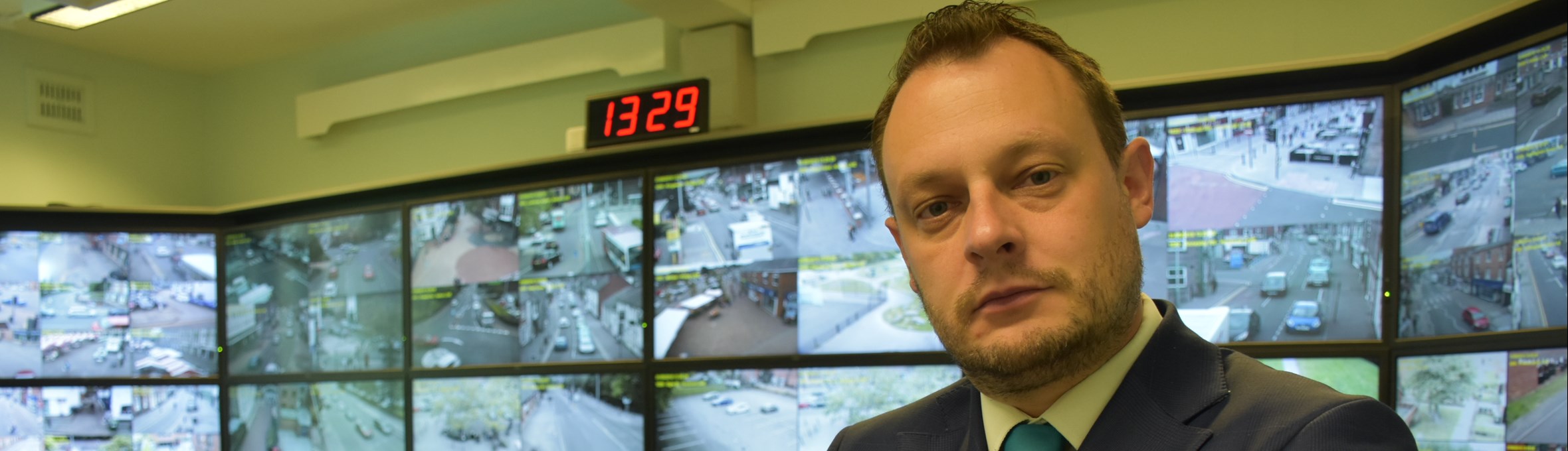 Councillor Jason Zadrozny stood in front of CCTV monitors 