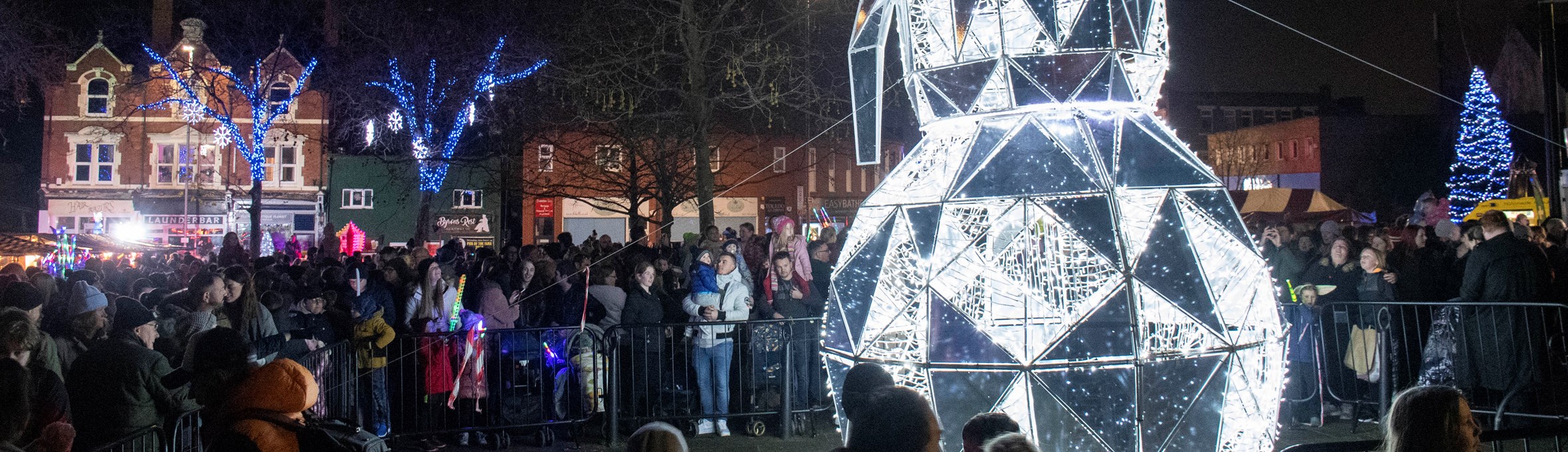 Crowds gathered around a giant LED snowman