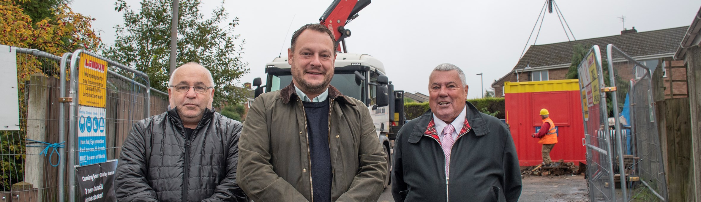 Three councillors stand in front of a building site on Darley Avenue. Kirkby